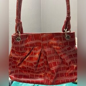 Women’s shiny red faux crocodile shoulder purse.